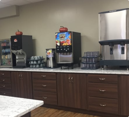 Office kitchen with coffee machines and water cooler