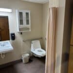 Accessible bathroom interior with safety grab bars.