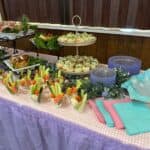 Catered buffet table with appetizers and veggies.