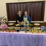 Catering staff with elegant buffet spread at event.