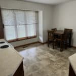 Empty kitchen with dining area and window blinds
