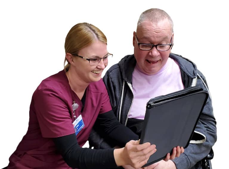 Nurse assisting man with tablet.