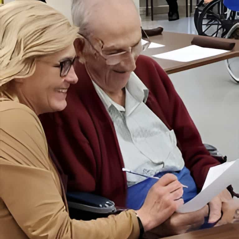 Elderly man and woman reviewing a document together.